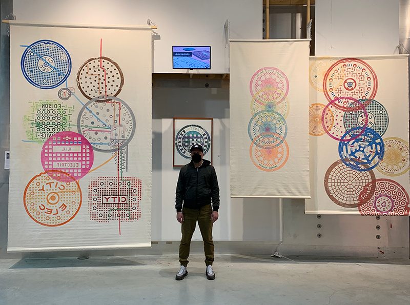 Russ Muits of Storm Print City in front of his large scale originals