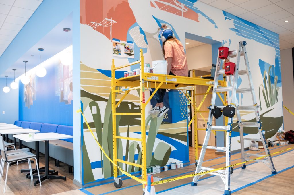 CERA paints mural at BMO seated on scaffold, copyright by ipaintmymind