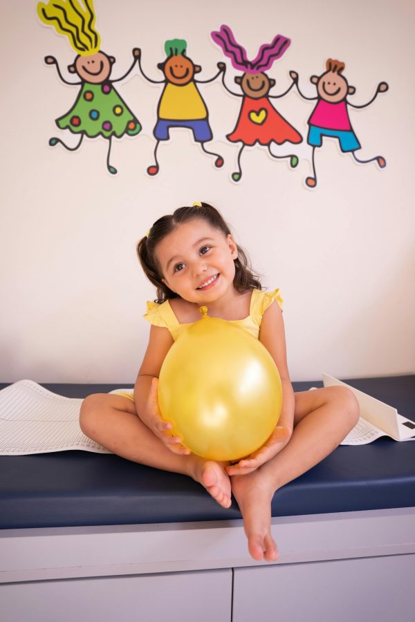 Little girl holding a balloon, showing an example of Healthcare Art
